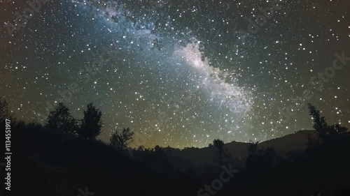 Night sky filled with stars and faint Milky Way, dark and vast, mysterious and infinite, cosmic and serene, natural beauty of the universe.