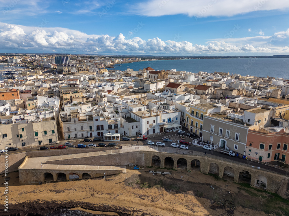 Fototapeta premium Aerial drone view of the coastal town named Gallipoli at the mediterranean sea in Italy.