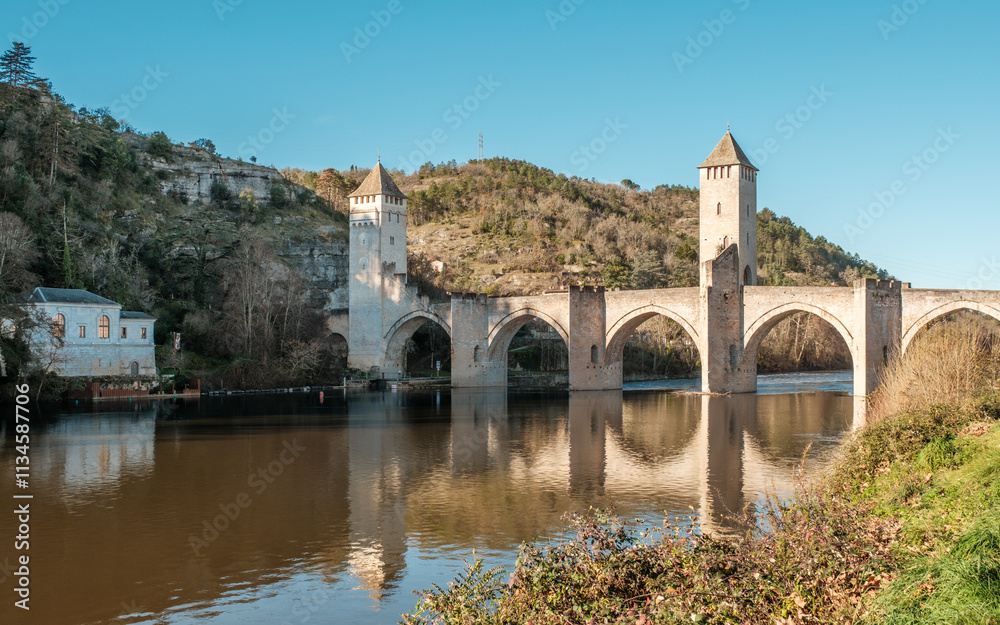 Fototapeta premium The 14th and 15th century Valentré bridge, a UNESCO World Heritage Site, crossing the Lot river in the town of Cahors in France