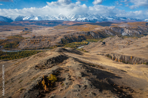 Mountain landscape in Altai during autumn with colorful forests and a clear sky.