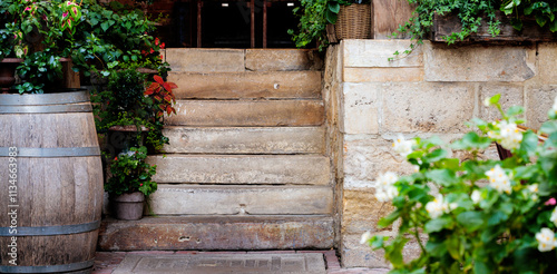 Fototapeta Naklejka Na Ścianę i Meble -  old Europe vintage style exterior design of patio restaurant rustic village street local view of aged stone walls and stairs, blossom plants spring season specific time
