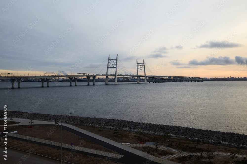 The stunning sunset view of a modern suspension bridge showcases an urban landscape at dusk The stunning sunset view of a modern suspension bridge showcases an urban landscape at dusk