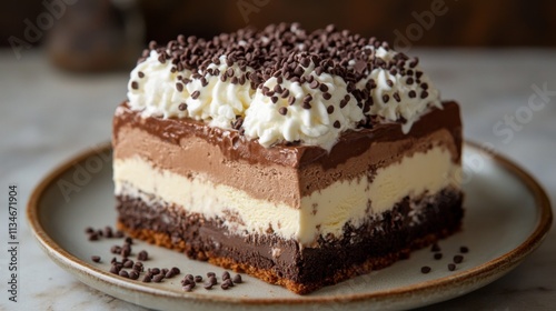 Slice of chocolate mousse cake on a white plate with cream