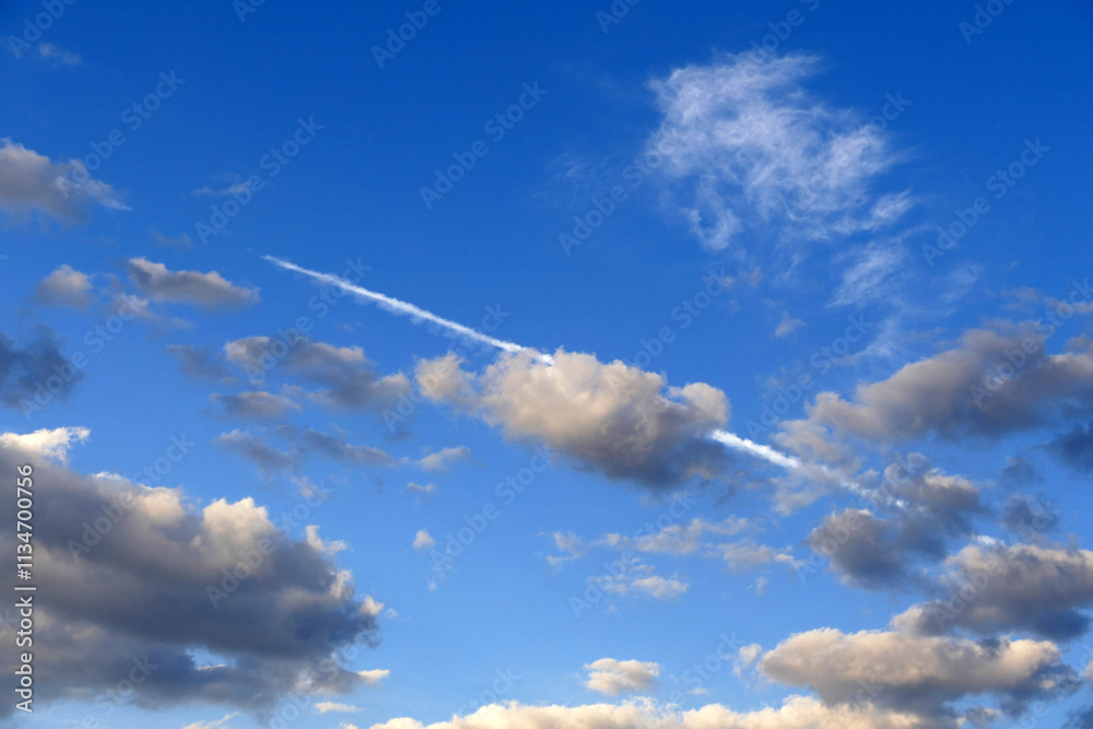 The white cloud trail left by the passenger plane in the sky The white cloud trail left by the passenger plane in the sky