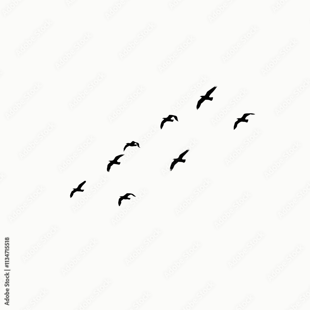 Fototapeta premium Silhouettes of a flock of birds flying against a white sky