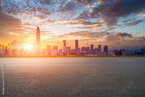 Fototapeta Naklejka Na Ścianę i Meble -  Empty asphalt road and cityscape with skyline in modern city at sunrise