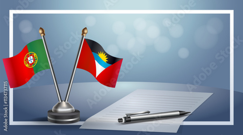 Portugal and Antigua and Barbuda National flags on small table with bokeh background, cooperative relationship