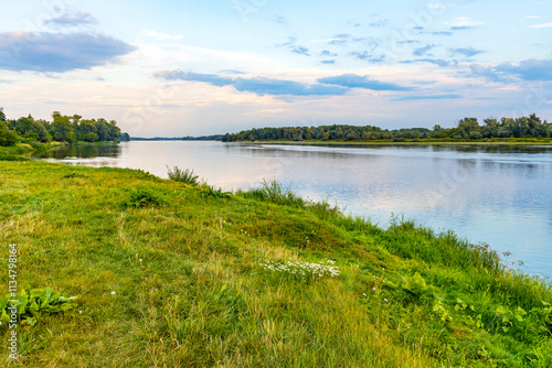 Vistula river landscape at summer early evening with riverside with wild beaches and embankment near Czerwinsk village in Mazovia region of Poland