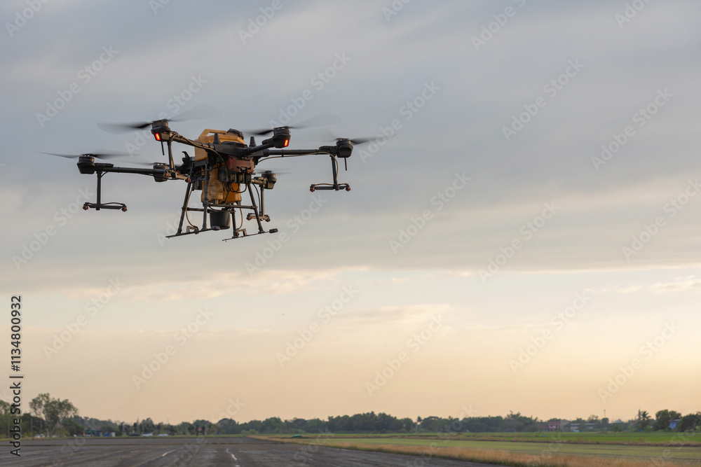 Agricultural drones and agricultural crops, Drones to spray fertilizer in rice fields. Agriculture drone flying above young rice fields to spraying fertilizer and pesticide farmland agricultural Agricultural drones and agricultural crops, Drones to spray fertilizer in rice fields. Agriculture drone flying above young rice fields to spraying fertilizer and pesticide farmland agricultural