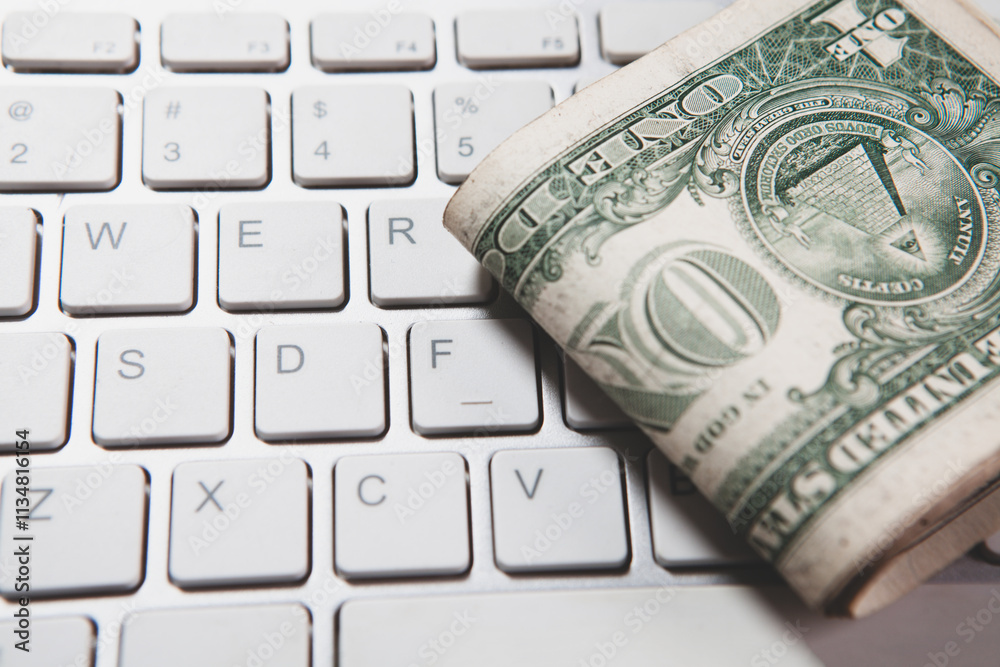 one dollar bills and a keyboar one dollar bills and a keyboar