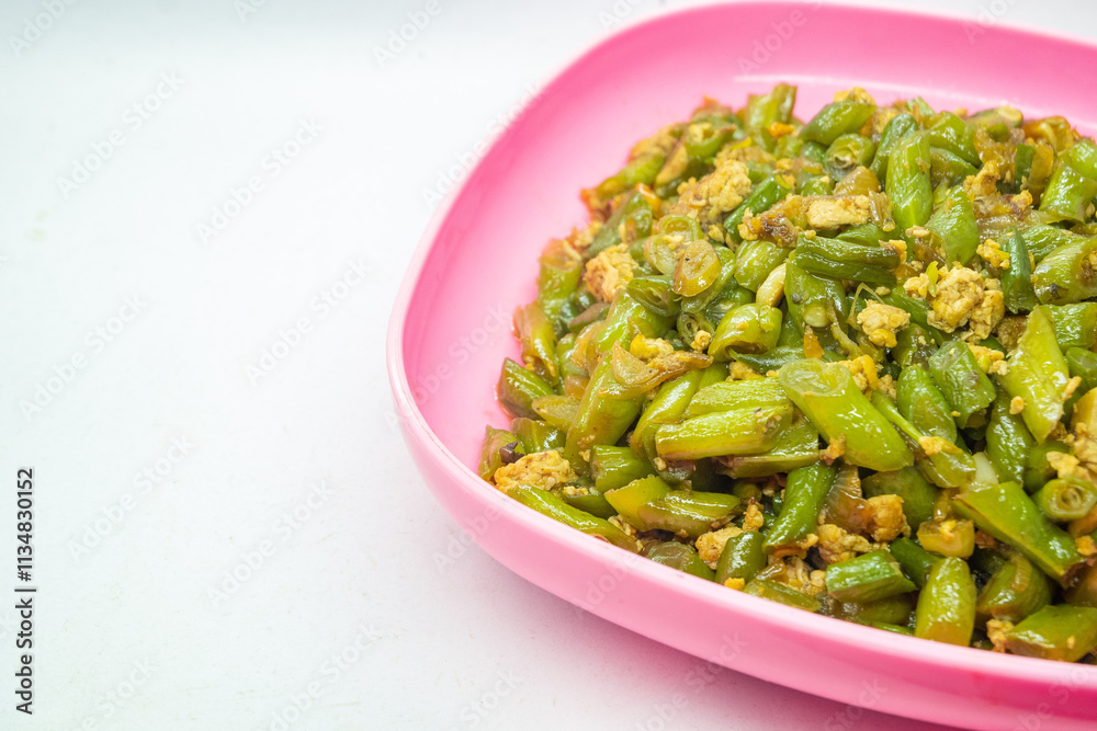 Stir-fried green beans mixed with chicken eggs served on a plate. isolated on white background Stir-fried green beans mixed with chicken eggs served on a plate. isolated on white background