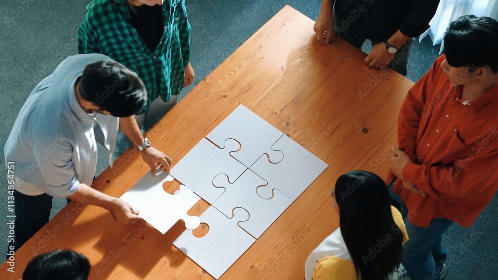 © Summit Art Creations - Top view of skilled business people gathering jigsaw piece together.Startup team with casual cloth standing at table while put jigsaw on table. Show unity, cooperation and team working. Convocation. © Summit Art Creations - Top view of skilled business people gathering jigsaw piece together.Startup team with casual cloth standing at table while put jigsaw on table. Show unity, cooperation and team working. Convocation.