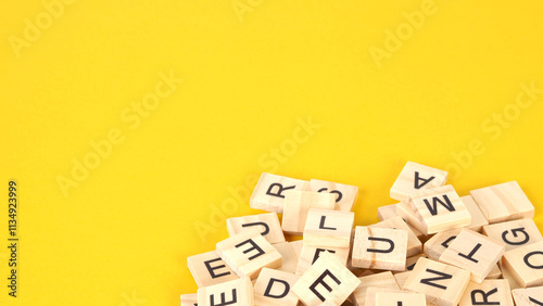 wooden letter cubes on yellow background