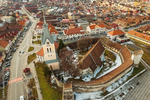 A breathtaking view captures the snow-dusted peaks of Piatra Craiului mountains alongside the historic Rasnov fortress photo