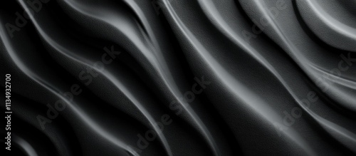 Abstract grayscale flowing fabric texture.