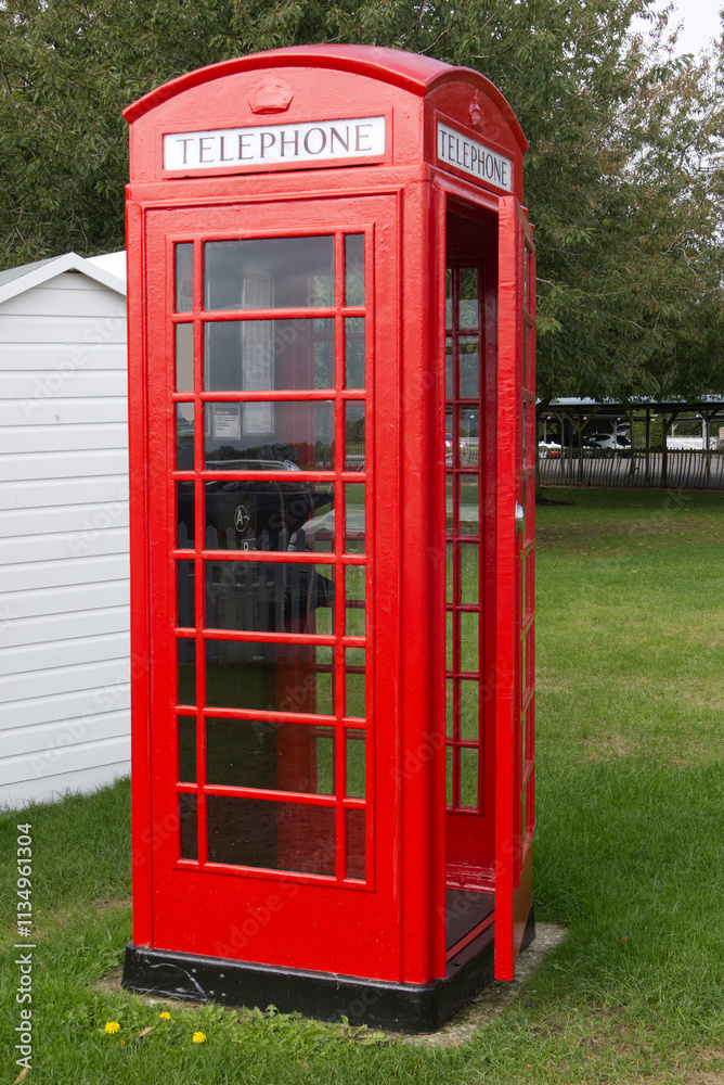 British red telephone box with door slightly open. British red telephone box with door slightly open.