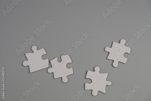 white jigsaw puzzle with missing puzzle for a text template. Above photo of isolated on the grey background