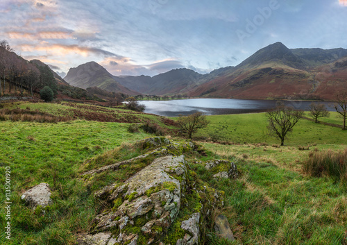 Beautiful Autumn sunrise landscape image of Buttermere in Lake District with Fleetwith Pike and Haystacks mountains photo