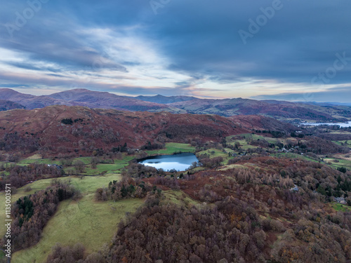 Moody aerial drone landscape image of Loughrigg Tarn in Autumn in Lake District at sunrise photo