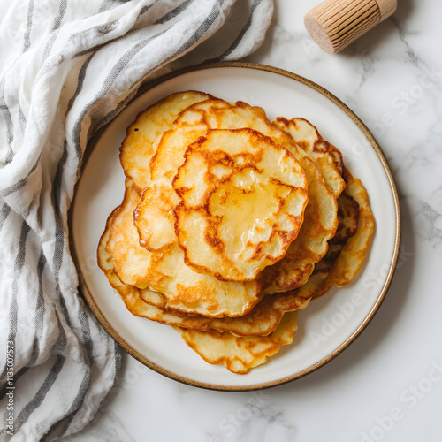 Homemade Crispy Potato Pancakes on Marble photo