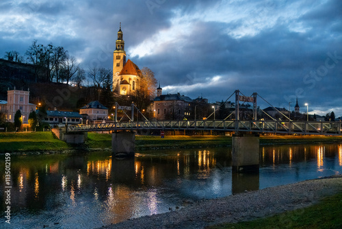 Night view of Our Lady of the Assumption church, Kirche Maria Himmelfahrt, on the foothills of the Monchsberg in Salzburg, Austria, along Salzach River photo