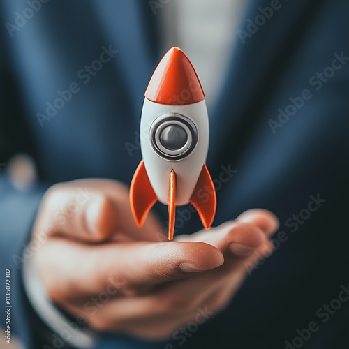 A businessman in a suit holding a small rocket model in his hand, representing a business startup, innovation, and the drive for growth and success. photo