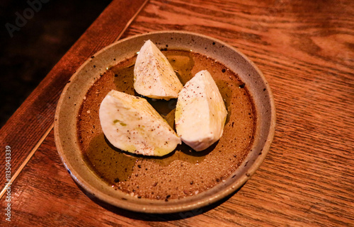 close up of mozzarella cheese in three quarter on a plate with copy space
