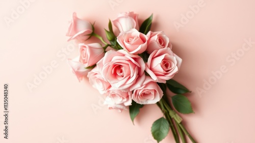 Delicate pink roses arranged in a bouquet against a soft blush background, showcasing the beauty of nature's delicate blooms.