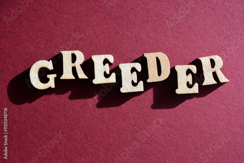 Greeder, greed and breed, portmanteau word in wooden alphabet letters isolated on background photo