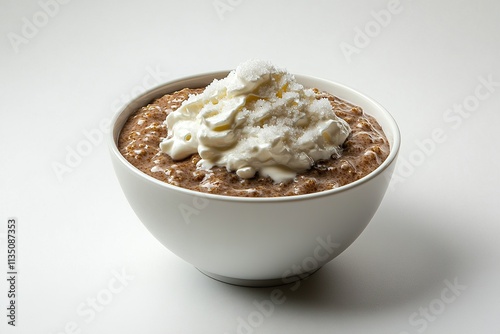 A bowl of Finnish mÃ¤mmi (rye pudding) served with cream and sugar. photo