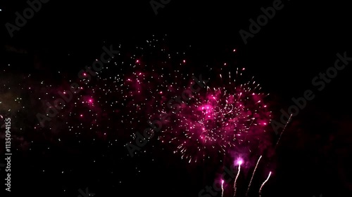 Bright colorful festive glowing fireworks on night sky.  New Year, Christmas, festival, party and holiday celebration concept