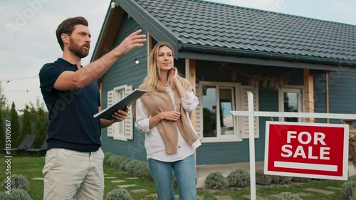 Wallpaper Mural Camera view of Caucasian male with beard holding notepad. Talking with woman. Explaining something while discussing property price. Real estate agent working. Female listening with focus. Torontodigital.ca