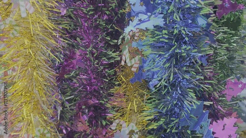 christmas tree decorations and colorful feathers background