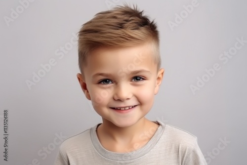 A young boy with a short haircut and a smile on his face
