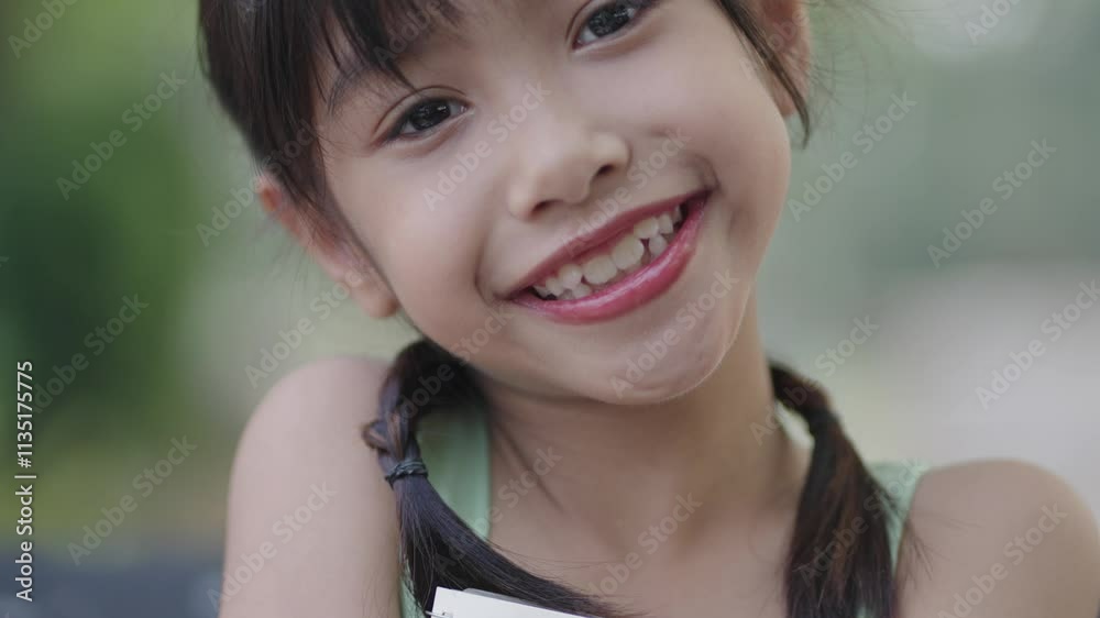 A girl is writing in a notebook in the garden. A girl is writing in a notebook in the garden.