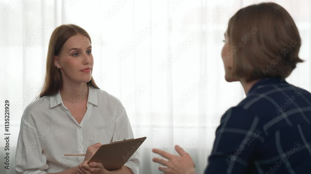 Happy patient and psychologist exchanging mental health conversation in clinic with positive emotion while explaining prim successful work and life to psychologist at psychologist clinic office Happy patient and psychologist exchanging mental health conversation in clinic with positive emotion while explaining prim successful work and life to psychologist at psychologist clinic office