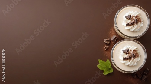 Creamy dessert jars with chocolate pieces and mint leaves on a dark background