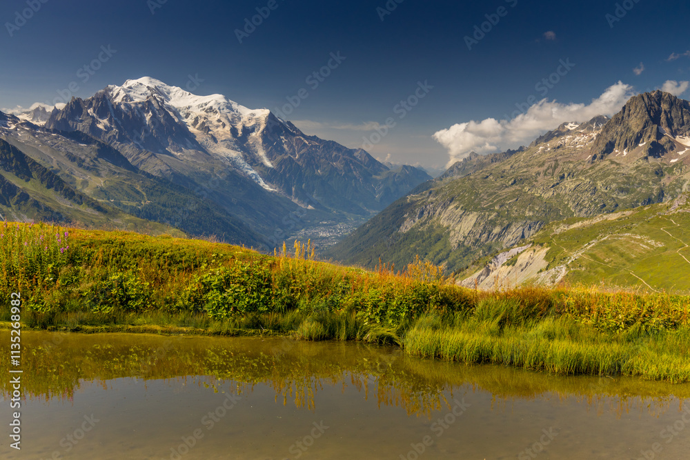 Fototapeta premium Mont Blanc, Monte Bianco mountain summit in the Alps. The highest mountain in Europe. Snow and glacier covered high altitude snow mountain in the Alps. The top of Montblanc Chamonix valley landscape
