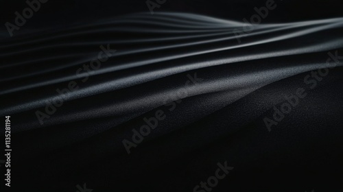 Soft contours of dark sand create elegant forms against subtle lighting