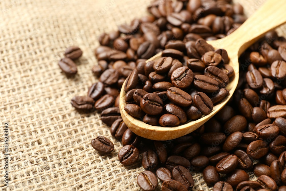 Wooden spoon with coffee beans on burlap Wooden spoon with coffee beans on burlap