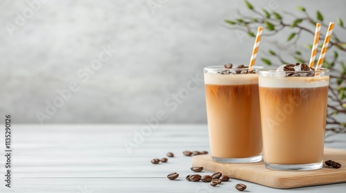 Chilled coffee drinks served with striped straws and coffee beans on a rustic...