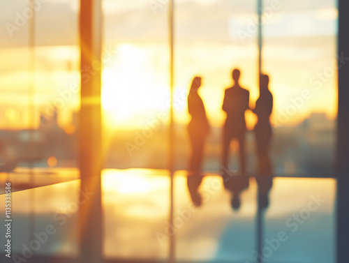 Business professionals engage in discussion during sunset in a modern office setting