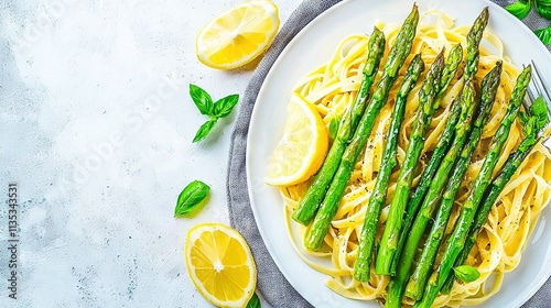   A plate of pasta, speckled with vibrant asparagus, glistening lemon wedges, and crumbled Parmesan cheese, sits atop a prist photo