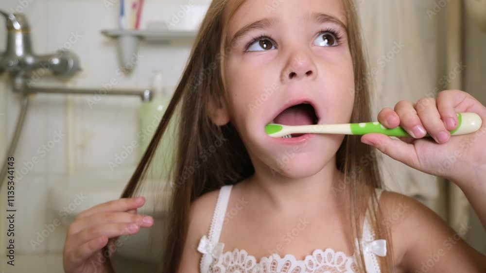 little girl brush her teeth in a bathroom
