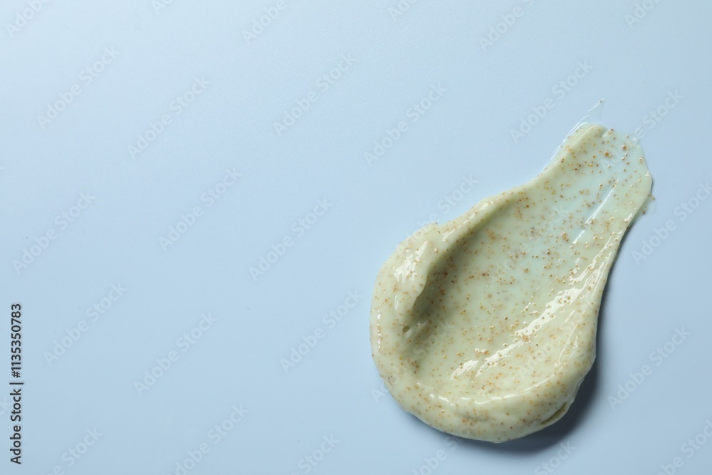 Smear of body scrub on light background, top view. Space for text