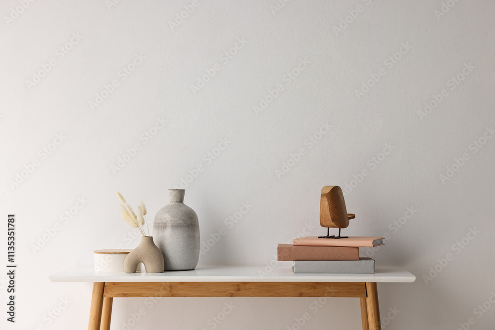 Stylish console table with decor near white wall indoors. Space for text Stylish console table with decor near white wall indoors. Space for text