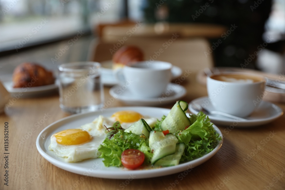 Delicious breakfast served on wooden table in cafe, closeup Delicious breakfast served on wooden table in cafe, closeup