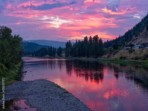 The sun sets over the Clark Fork River in the town of Superior, Montana, USA