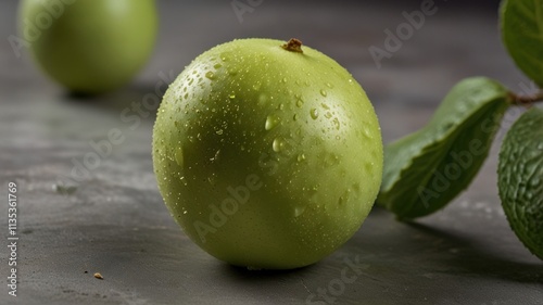 Close-up of fresh, green fruit with water droplets.