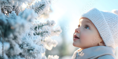 Enthusiastic child looks at a decorated outdoor Christmas tree. Decorating the city for the new year, children event, miracle 